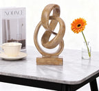 Abstract wood-toned knot sculpture, geometric decorative statue, wood-toned accent piece for living room coffee table or bookshelf surface, office TV cabinet or entryway console table decoration.