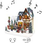 MOMENTS IN TIME Christmas Village Building Lighted Christmas Shop with LED Lights, Music & Snowman Battery Operated or Plug-in Vintage Holiday Village House Décor 8.5”H x 9.8”W x 6.9”D