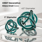 Torre & Tagus Orbit Hand Blown Glass Infinity Knot Sculpture - 3 Inch Glass Art Teal Knot Decor Ball for Home Decor, Small Centerpiece Table Decoration for Home Interior (Clear Teal)