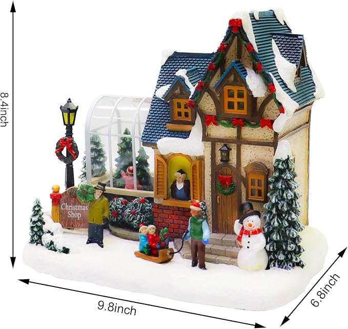 MOMENTS IN TIME Christmas Village Building Lighted Christmas Shop with LED Lights, Music & Snowman Battery Operated or Plug-in Vintage Holiday Village House Décor 8.5”H x 9.8”W x 6.9”D