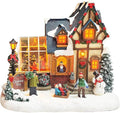 MOMENTS IN TIME Christmas Village Building Lighted Christmas Shop with LED Lights, Music & Snowman Battery Operated or Plug-in Vintage Holiday Village House Décor 8.5”H x 9.8”W x 6.9”D