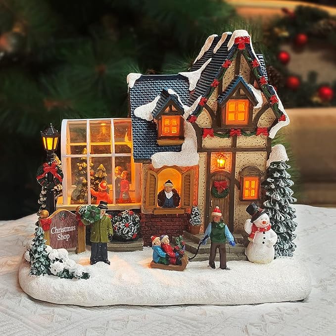 MOMENTS IN TIME Christmas Village Building Lighted Christmas Shop with LED Lights, Music & Snowman Battery Operated or Plug-in Vintage Holiday Village House Décor 8.5”H x 9.8”W x 6.9”D
